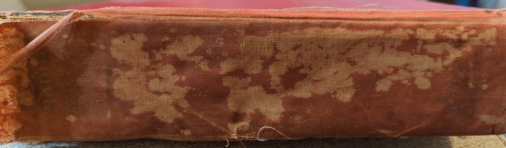 Spine of the W6SAI handbook. The spine is well worn, blotchy and faded, not in the greatest shape, and needs to be reattached to the binding.