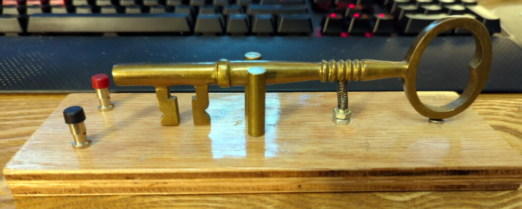 A vintage looking brass key mounted on a plywood base.  The key is mounted to act as a straight key for tapping out Morse code.