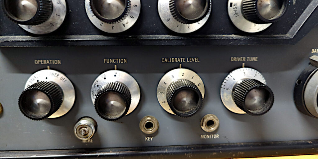 Lower left row of knobs on the Hallicrafters HT-32 showing the Operation, function, calibrate leve, and driver tune knobs. Below are the microphone, key, and monitor plugs.