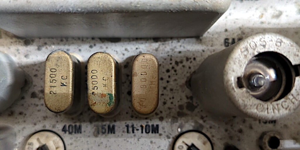 Three crystals in the Hallicrafters HT-32. The crystals are marked 21500 kcycles, 25000 kcycles, and 30.9 MHz.